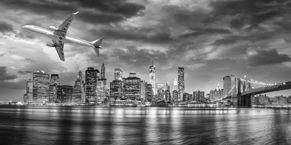 Black and white view of airplane overflying New York City.